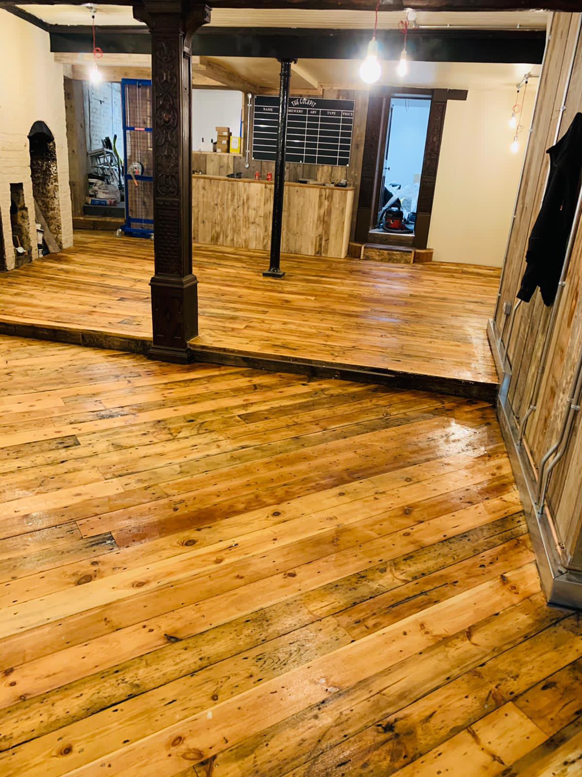 Reclaimed Victorian floorboards laid throughout a bar fit-out