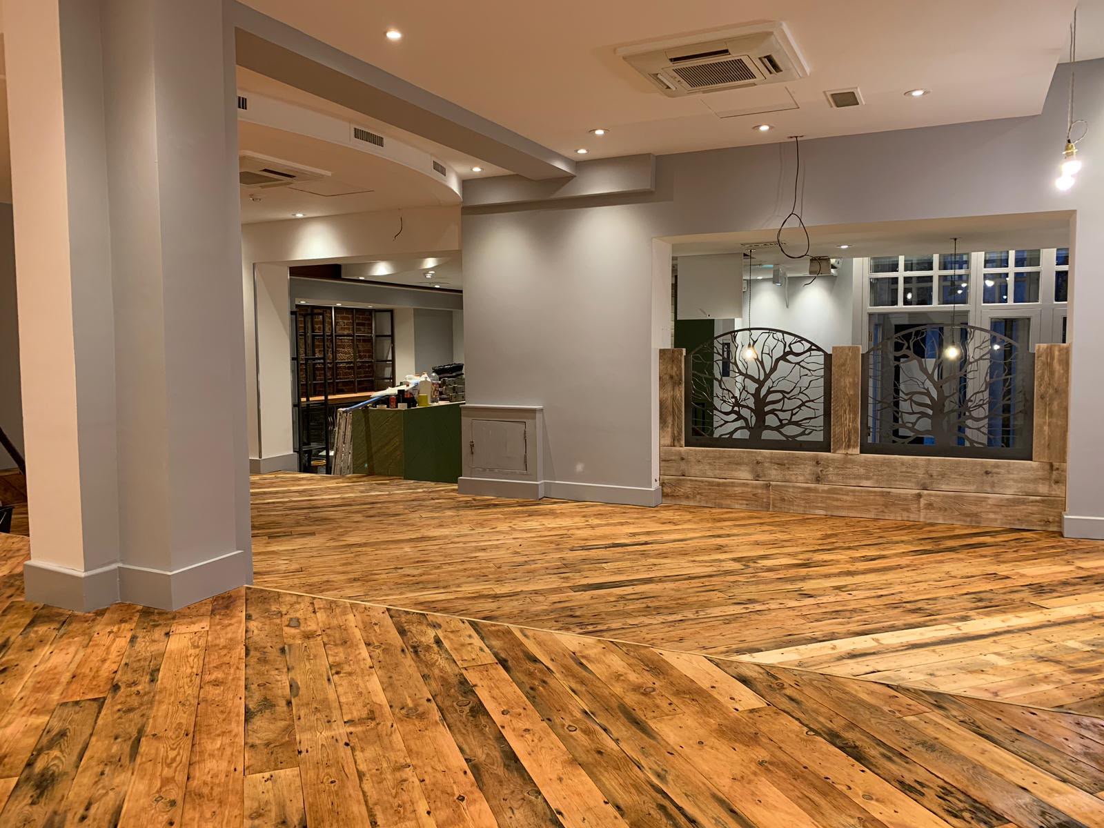 Reclaimed Victorian pine floorboards laid in a London commercial fit-out